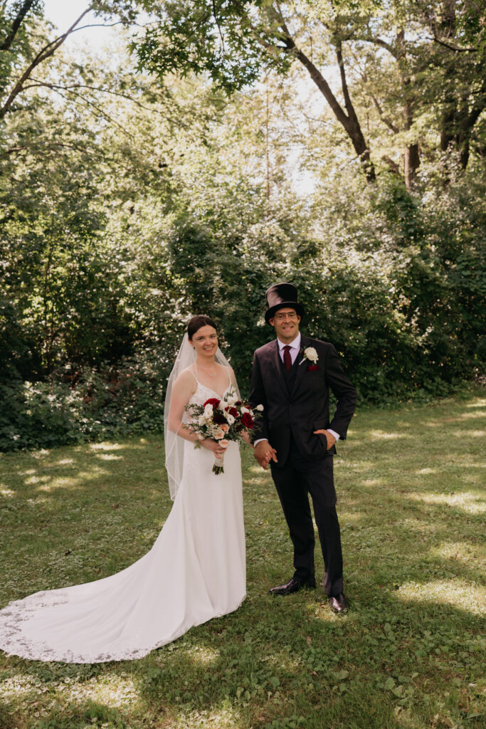 Full-length portrait of bride and groom standing together in dappled shade at Keller Golf Course