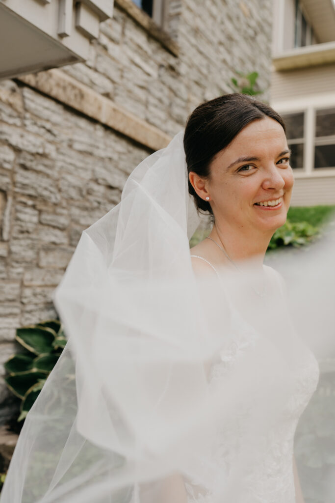 Close portrait of bride under her veil outside Mount Olive Lutheran Church