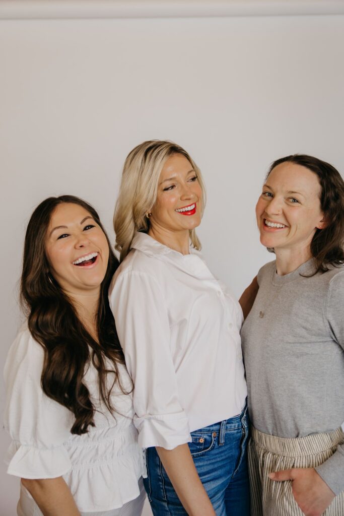 Integrative medicine team smiling arm in arm during a Minneapolis group brand photography session