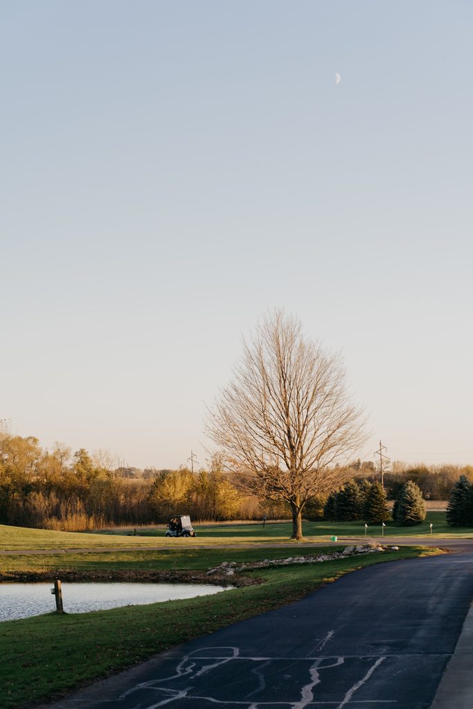 Dusk view of the golf course at Ridges at Sand Creek with a pond and moon